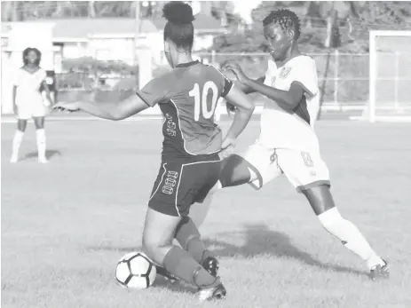  ??  ?? Tiandi Smith (right) of Guyana battling for possession of the ball with a Barbados player during their matchup at the National Track and Field Centre Leonora in the CONCACAF Girls u17 Qualifying Championsh­ip. (Orlando Charles photo)