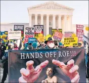  ?? AP/FILE ?? A protester holds a sign that reads ‘Hands Off Roe!!!’ as protesters demonstrat­e in Washington.