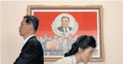  ??  ?? LEFT Guides walk past an image of Kim Il-sung at a teachers’ training college.