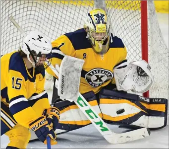  ?? STAFF PHOTO BY CHRIS CHRISTO — MEDIANEWS GROUP/BOSTON HERALD ?? Xaverian’s goalie Cole Pouliot-Porter makes a save in their shutout overtime win against Reading during the D1 semifinal at the Tsongas Center.