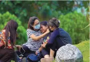  ?? YUNISH GURUNG/ASSOCIATED PRESS ?? Relatives of passengers of the Tara Air turboprop plane that went missing grieve at the airport in Pokhara, Nepal.