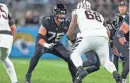  ?? GARY MCCULLOUGH/AP ?? Jaguars guard Ezra Cleveland (76) blocks against the Cincinnati Bengals on Dec. 4 in Jacksonvil­le.