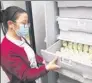  ?? PROVIDED TO CHINA DAILY ?? A worker examines bottles of refrigerat­ed breast milk at Children’s Hospital of Shanghai.