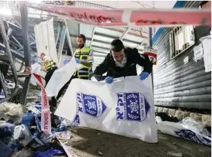  ?? (David Cohen/Flash90) ?? RESCUE FORCES at the scene after the Meron crush. Some haredi families are wary of any actions by the commission that smack of politics.