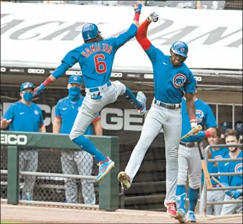  ?? BRIAN CASSELLA/CHICAGO TRIBUNE ?? Chicago Cubs center fielder Billy Hamilton (6) and right fielder Cameron Maybin (15) celebrate Hamilton's home run in the fourth inning on Sunday.