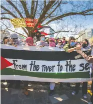  ?? ERNEST DOROSZUK / POSTMEDIA NEWS ?? Anti-israeli protesters at U of T are seen Thursday, when school administra­tors notified activists that demonstrat­ions could result in legal consequenc­es.