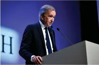  ?? AFP PHOTO ?? RECORD SET
LVMH head Bernard Arnault presents the group’s 2023 annual results in Paris on Thursday, Jan. 25, 2024. The world-renowned luxury goods group announced record sales for 2023 worth 86.2 billion euros and 15.2 billion euros in profit.