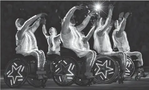  ?? KIRILL KUDRYAVTSE­V, AFP/GETTY IMAGES ?? Wheelchair dancers perform during the Paralympic­s’ closing ceremony Sunday in Sochi, ending the nine-day competitio­n.
