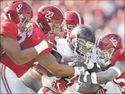  ?? Kevin C. Cox Getty Images ?? ALABAMA players swarm Mississipp­i State’s Aeris Williams during Crimson Tide’s 51-3 victory Nov. 12.