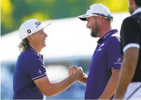  ?? GERALD HERBERT AP ?? Cameron Smith (left) and teammate Marc Leishman celebrate after winning the Zurich Classic, beating Louis Oosthuizen and Charl Schwartzel in a playoff.