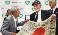  ?? (Reuters) ?? US WWII veteran Marvin Strombo meets with Tatsuya Yasue (left), brother of Sadao Yasue, on Tuesday in Higashi-Shirakawa Village, Japan, to hand over a Japanese flag Strombo found in a battlefiel­d in 1944.