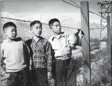  ?? THE ASSOCIATED PRESS ?? Children stand behind the fence at the Manzanar Relocation Center near Independen­ce, where JapaneseAm­ericans were incarcerat­ed during World War II.