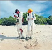  ??  ?? EMLYN Hughes and Gemma Sahwell test soil on Naen Island, where radioisoto­pe levels were about the same as those at the biggest blast site 100 miles away.