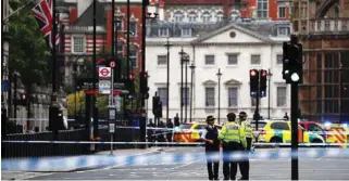  ?? - File photo ?? ON GUARD: Police stand in the street outside the Houses of Parliament in Westminste­r, London.