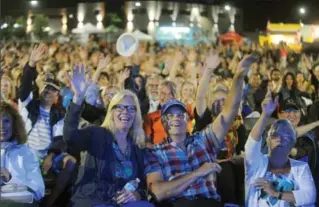  ?? DAVID BEBEE, RECORD STAFF ?? A large audience including Cindy and Scott Chatham, middle, react to singer Matt Dusk’s decision to take a photo of them during a break in his performanc­e Saturday at the Uptown Waterloo Jazz Festival.