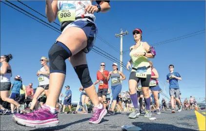  ?? KEITH GOSSE/THE TELEGRAM ?? Runners make their way down Topsail Road in Mount Pearl during the 90th running of the Tely 10 road race Sunday morning.