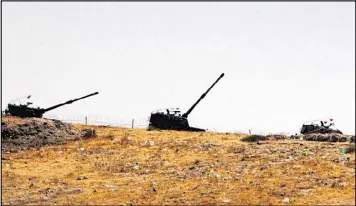  ??  ?? Turkish artillery forces take positions Wednesday in Karkamis, Turkey, near the Syrian border. Turkey’s surge this week into Syria, assisted by U.S. warplanes, is a significan­t escalation of Turkey’s role in the fight against the Islamic State.
