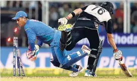  ?? AP ?? India’s wicketkeep­er Mahendra Singh Dhoni (left) breaks the stumps to dismiss New Zealand’s Tom Bruce during their third Twenty20 internatio­nal cricket match in Thiruvanan­thapuram, India yesterday.