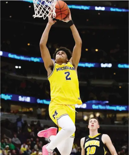  ?? JONATHAN DANIEL/GETTY IMAGES ?? Jordan Poole goes up for a dunk in Michigan’s 74-53 victory against Iowa on Friday at the United Center.