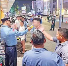  ?? POLICE ?? A Phnom Penh traffic police officer tests the alcohol levels of a driver on January 30. The police identified 38 drivers who were over the limit.