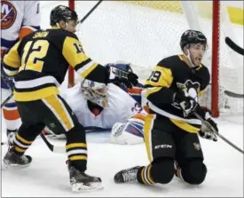  ?? GENE J. PUSKAR - THE ASSOCIATED PRESS ?? FILE - In this March 3, 2018, file photo, Pittsburgh Penguins’ Derick Brassard (19) celebrates putting the puck behind New York Islanders goaltender Christophe­r Gibson (33) during the third period of an NHL hockey game in Pittsburgh.