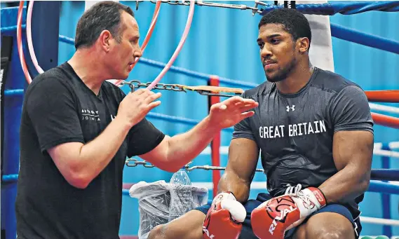  ??  ?? Guiding hand: Robert McCracken works with Anthony Joshua ahead of the Briton’s fight against Wladimir Klitschko on Saturday