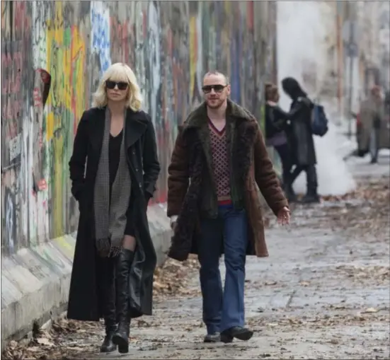  ?? JONATHAN PRIME/FOCUS FEATURES VIA AP ?? This image released by Focus Features shows Charlize Theron, left, and James McAvoy in “Atomic Blonde.”
