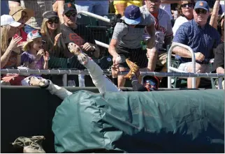  ?? ROSS D. FRANKLIN — THE ASSOCIATED PRESS ?? Giants third baseman Wilmer Flores, center bottom, tosses the ball to a teammate after making a diving catch on a foul ball hit by San Diego's Graham Pauley in Saturday's spring training game in Scottsdale, Ariz.