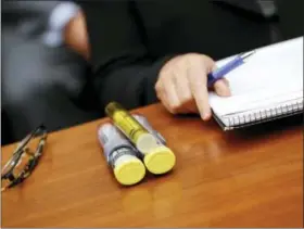  ?? PABLO MARTINEZ MONSIVAIS - THE ASSOCIATED PRESS ?? In this Sept. 21, 2016, photo, EpiPens brought by Mylan CEO Heather Bresch are seen on Capitol Hill in Washington as she testified before the House Oversight Committee hearing on EpiPen price increases. Senators are asking the Justice Department to...