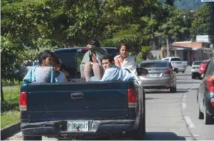  ??  ?? SAN PEDRO SULA, Honduras: Youngsters are driven home in a pickup after they were deported from Mexico to this city on Jan 18, 2017. – AFP