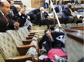  ?? ANDREW HARNIK AP ?? People shelter in the House gallery as a mob tries to break into the House on Wednesday in Washington, D.C.