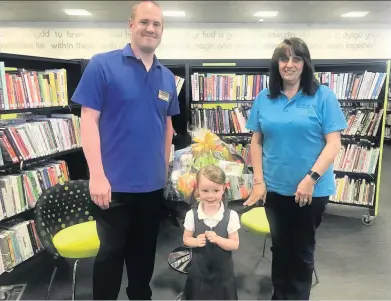  ??  ?? Martin Blackwell, of The Works Llanelli, competitio­n winner Eleri Evans and Giovanna Sinfield Llanelli Library.