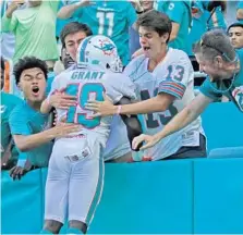  ?? JOHN MCCALL/SUN SENTINEL ?? Wide receiver Jakeem Grant jumps into the stands after scoring the touchdown on a trick play, a pass from Albert Wilson.