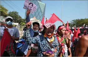  ?? REUTERS ?? Demonstrat­ors hold up signs during a protest against the military coup and demanding the release of elected leader Aung San Suu Kyi, in Yangon, Myanmar, on Saturday.