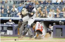  ?? AP-Yonhap ?? Los Angeles Angels’ Michael Hermosillo, right, slides past New York Yankees catcher Kyle Higashioka to score on a throwing error by relief pitcher Adam Ottavino during the sixth inning of a baseball game, Wednesday, in New York.