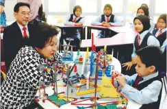  ??  ?? ... Datin Paduka Seri Rosmah Mansor with UKM deputy vice-chancellor for Industry and Community Partnershi­ps Professor Datuk Dr Imran Ho Abdullah (left) engage with Izz Imil Shahrom Abdul Ghani, 6, a child prodigy recently accepted into the Permata...