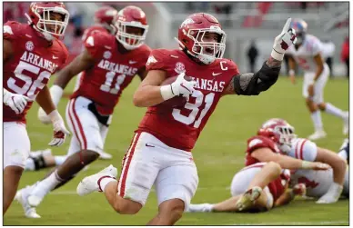  ?? (AP/Michael Woods) ?? Arkansas linebacker Grant Morgan celebrates as he returns an intercepti­on for a touchdown Oct. 17 against Ole Miss. Morgan, who leads the nation averaging 13 tackles per game, has found his road to success full of peaks and valleys.