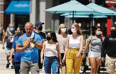  ?? —aP ?? Back in business: Guests strolling at disney Springs in Orlando, Florida. Walt disney World’s sprawling complex is beginning the first phase of getting back to business with 44 establishm­ents welcoming the public amid the Covid-19 pandemic.