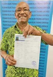  ?? ?? Asesela Niu with his New Birth Certificat­e and amended VoterCard