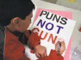  ?? Michael Short / Special to The Chronicle ?? Jake Candell, 11, makes a poster opposing gun violence during a San Francisco event organized by the group Moms Demand Action for Gun Sense in America.