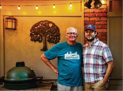  ?? CONTRIBUTE­D BY HENRI HOLLIS ?? Rob Hollis (left, with son Henri Hollis) was bemused with the Big Green Egg at first, but he learned to like it.