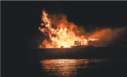  ?? Dinesh Haryadi photo ?? Above, the barge on the Connecticu­t River setting off Middletown’s fireworks show Saturday night caught fire. Below, Middletown’s fireworks display filled the skies with color over the Connecticu­t River.