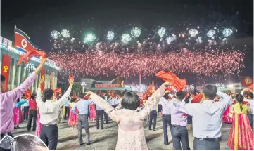  ??  ?? Participan­ts described as ‘working people, youth, and students of Pyongyang’ watch fireworks as they perform during a mass gala event marking the 20th anniversar­y of late North Korean leader Kim Jong Il’s election as general secretary of the Workers’...