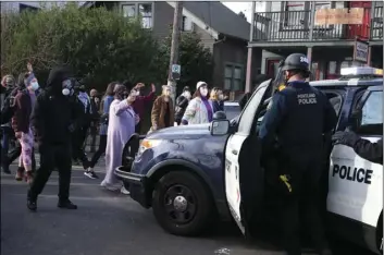  ?? BETH NAKAMURA/THE OREGONIAN VIA AP ?? Protesters who have camped for months to prevent a Black and Indigenous family from being forced to leave a home took the property back Tuesday, after morning clashes with police, who said they were working to “re-secure” the foreclosed home.