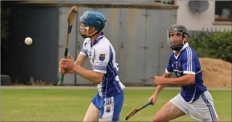  ??  ?? Craanford’s Kevin Poole in the process of scoring a point despite the presence of Oylegate-Glenbrien’s Robert O’Connor.