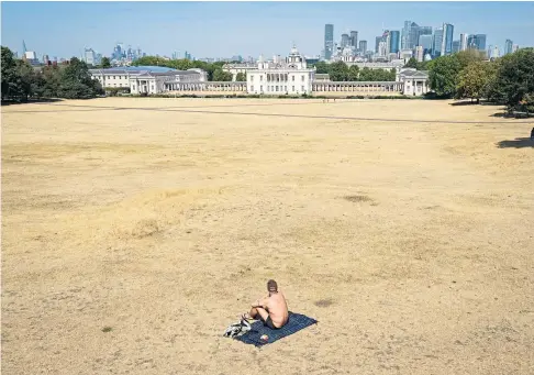  ?? ?? HEATWAVE: A parched Greenwich Park, London, yesterday after an official drought was declared for parts of England – but thundersto­rms and heavy rain, which have already hit parts of Scotland, could be on the way.