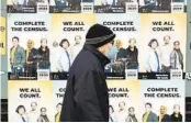  ?? TED S. WARREN AP FILE ?? A man wearing a mask walks past posters encouragin­g participat­ion in the 2020 Census in Seattle. The Census Bureau says it is ready to start examining changes to the questionna­ire for 2030.