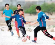  ?? — AFP ?? Yemeni youth play a football match in their neighbourh­ood in Sanaa.