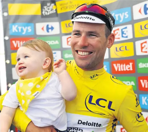  ??  ?? Daddy cool: Dimension Data rider Mark Cavendish beams with delight while holding his young son, Frey, after victory in the first stage of the 103rd Tour de France