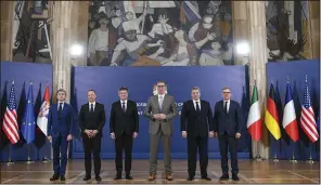  ?? (AP/Serbian Presidenti­al Press Service) ?? Serbian President Aleksandar Vucic (third right) poses with Italian diplomat Alessandro Cattaneo (left), French presidenti­al adviser Emmanuel Bonne (second left), European Union envoy Miroslav Lajcak (third left), U.S. Deputy Assistant Secretary Gabriel Escobar (second right) and the German chancellor’s adviser, Jens Plettner (right), in Belgrade, Serbia, on Saturday.